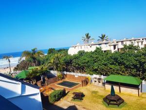 a view of a resort with a swimming pool and the beach at Dumela Margate Flat No 17 in Margate