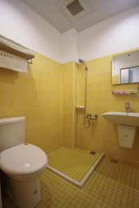 a bathroom with a toilet and a sink at Sun Fog Hotel in Yuchi