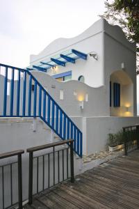 a house with blue stairs in front of it at Sun Fog Hotel in Yuchi