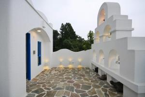 a hallway of white buildings with a stone floor at Sun Fog Hotel in Yuchi
