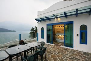 a patio with tables and chairs next to the water at Sun Fog Hotel in Yuchi