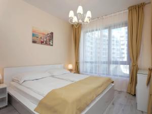 a bedroom with a bed and a large window at Varna South Bay Beach Residence in Varna City +55 photos