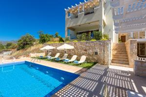 a villa with a swimming pool and a house at Kampos Villas, pure elegance, By ThinkVilla in Achlades