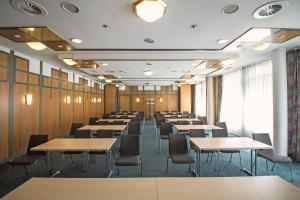 a conference room with tables and chairs in it at Serways Hotel Remscheid in Remscheid