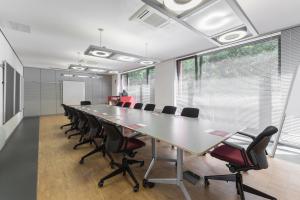a large conference room with a long table and chairs at Serways Hotel Feucht Ost in Feucht