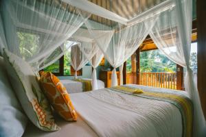 A bed or beds in a room at Kano Sari Ubud Villas