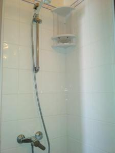 a shower with a shower head in a bathroom at Morbey's Chalet in Sintra