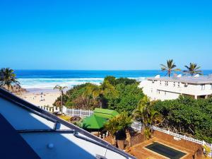 a view of a beach and the ocean from a balcony at Dumela Margate Flat No 31 in Margate