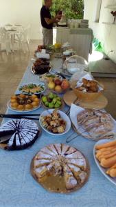 una mesa con muchos tipos diferentes de comida en ella en Tenuta Molino di Mare en Rodi Garganico