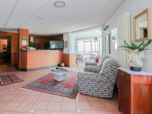 a living room with a couch and a chair at Hotel Funivia in Laveno-Mombello