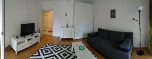 a living room with a couch and a tv at Apartment Homey in Zadar