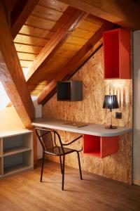 a desk with a lamp and a chair in a room at Moontain Hostel in Oz +23 photos