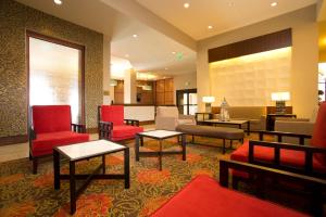 
a living room filled with furniture and a red carpet at Ramada Plaza Resort & Suites By Wyndham Orlando International Drive in Orlando
