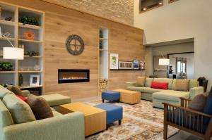 a living room with couches and a fireplace at Country Inn & Suites by Radisson, Indianola, IA in Indianola