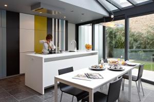 a kitchen with a woman in a sink and a table at Bruges by Night in Bruges