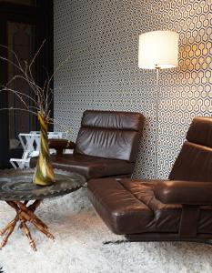 a living room with a leather couch and a table at Bruges by Night in Bruges