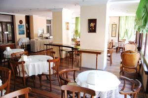 a dining room with tables and chairs in a restaurant at Triana Hotel in Antalya
