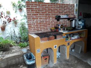 a pretend kitchen in a brick wall with a table at Casa Azul in Valladolid