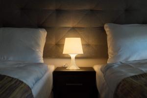 Łóżko lub łóżka w pokoju w obiekcie City Rooms Szczecin