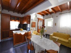a kitchen and living room with a table and a couch at Akadia Syros in Ermoupoli