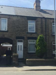 a brick house with a white door at Cosy house in Wombwell in Barnsley