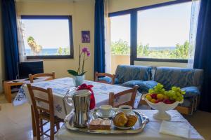 a dining room table with a plate of food on it at Residence Le Saline in Marsala