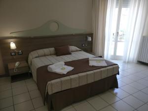 מיטה או מיטות בחדר ב-Hotel I Pini