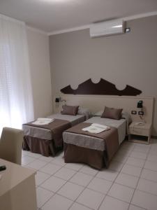 Postel nebo postele na pokoji v ubytování Hotel I Pini