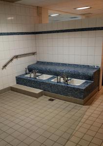 a public bathroom with two sinks in a room at Apartment Regina in Möhnesee