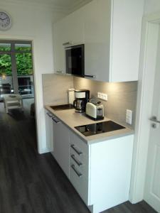 a kitchen with a counter with a toaster and a microwave at Apartment Regina in Möhnesee