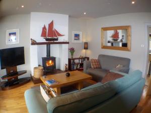 a living room with a couch and a table at 16 Admiralty in Arrochar