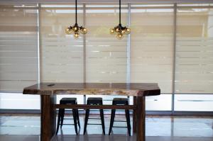 a wooden table with chairs in front of a window at Hotel Expo Abastos in Guadalajara