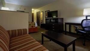 a hotel room with a couch and a coffee table at Best Western Plus Huntersville in Huntersville