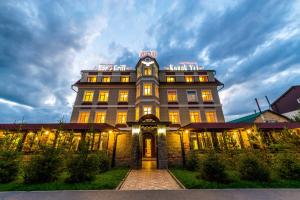 a building with a clock on the top of it at Adler in Astana