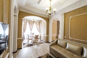 a living room with a couch and a table at Adler in Astana