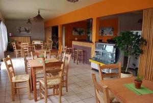 a restaurant with tables and chairs and a dining room at Alecrim Pousada in Praia do Rosa