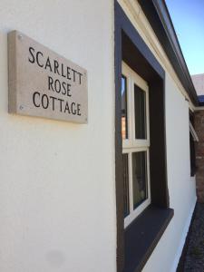 a sign on the side of a house that reads scarlet roast coffee at Scarlett Rose Cottage in Cookstown