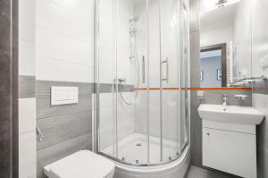 a bathroom with a shower and a toilet and a sink at Villa Baltica II in Rewa +45 photos