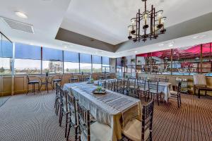 a restaurant with tables and chairs and a bar at Plaza Resort Club Reno in Reno