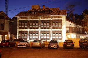 a large building with cars parked in front of it at Posada-Spa Privilegio de Vara in Noja