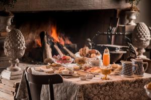 a table topped with lots of food on top of a fire place at Rio do Rastro Eco Resort in Bom Jardim da Serra