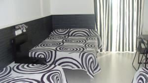 A bed or beds in a room at Hostal JQ Madrid 1