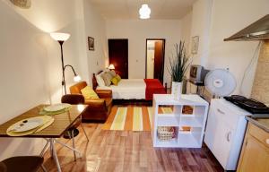 a small living room with a bed and a kitchen at Mértola low-cost in Mértola