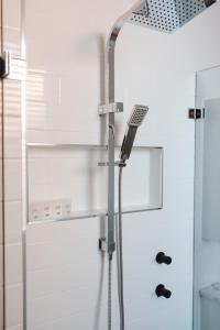 a shower with a glass door in a bathroom at Bespoke On Main in Rutherglen