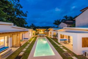 an exterior view of a villa with a swimming pool at La Ramona Charming Hotel in Tamarindo