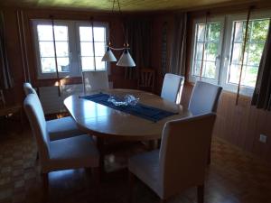 a dining room with a wooden table and chairs at Ferienhaus Brand in Gais