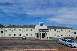 a large white building with a parking lot at Motel 6-Wheatland, WY in Wheatland