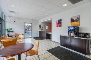a restaurant with tables and chairs and a kitchen at Motel6 Winchester, VA in Winchester