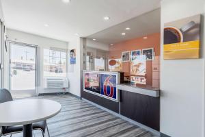 a waiting room with a table and a tv at Motel 6-Barstow, CA - Route 66 in Barstow