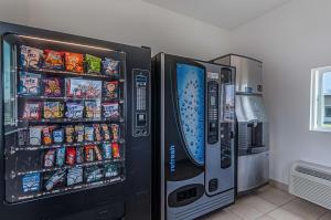 two vending machines with drinks and snacks in a room at Motel6 Winchester, VA in Winchester